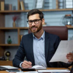 Executive smiling holding documents